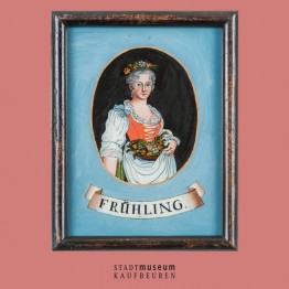 Hinterglasbild: Ovales Portrait einer Frau im Dirndl und Blumenkranz im Haar und Blumenkorb in der Hand. Darunter steht &quot;Frühling&quot; geschrieben